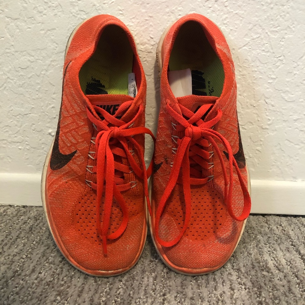 Orange Nike flyknit free runs